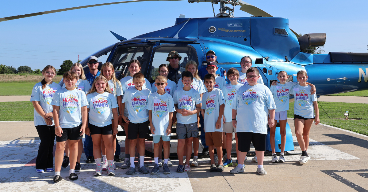 Healing Hands Summer Camp Students Standing by ARCH Helicopter