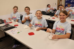 Healing Hands Summer Camp Students making slime to simulate how blood clots after a presentation from an MLT.