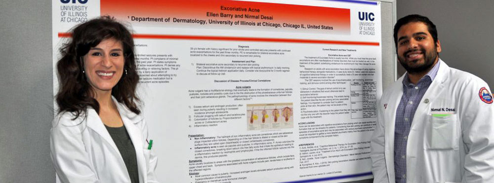UMed students Ellen Barry and Nirmal Desai stand before their poster on excoriative acne,