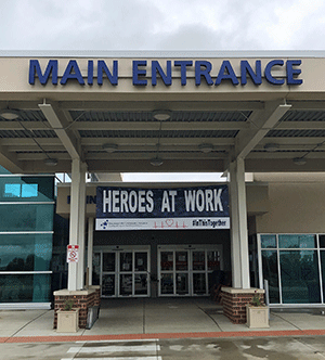 Main entrance to Pinckneyville Community Hospital, with giant Heroes at Work banner over door.