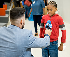 ABC Chicago News interviews a young participant in the Black Men in White Coats youth summit.