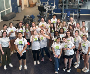 Participants post for a group shot in their Healthcare Careers Camp 2024 T-shirts.