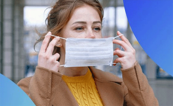 Woman putting on a face mask.