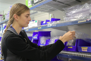 Preceptorship participant sorting health care related supplies.