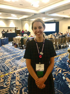UMed student Maya McKeown, with AMA House of Delegates in the background.