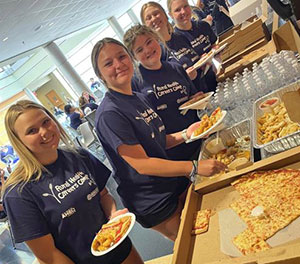 Rural Health Careers Campers show off their T-shirts and enjoy some well-earned pizza.