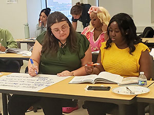 Participants working in teams compare notes during Mental Health First Aid training at the 2024 UHE.