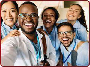 Jubilant, diverse health professional pose for a group shot.