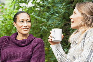 Two women having a discussing outside.