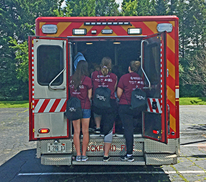 Summer program participants getting the inside look at an ambulance.