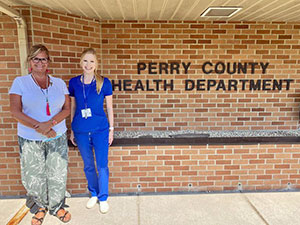 Two participants pose by the Perry County Health Department sign.